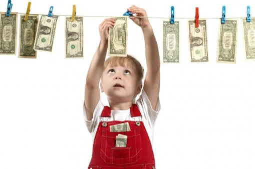 Child hanging money on a clothesline