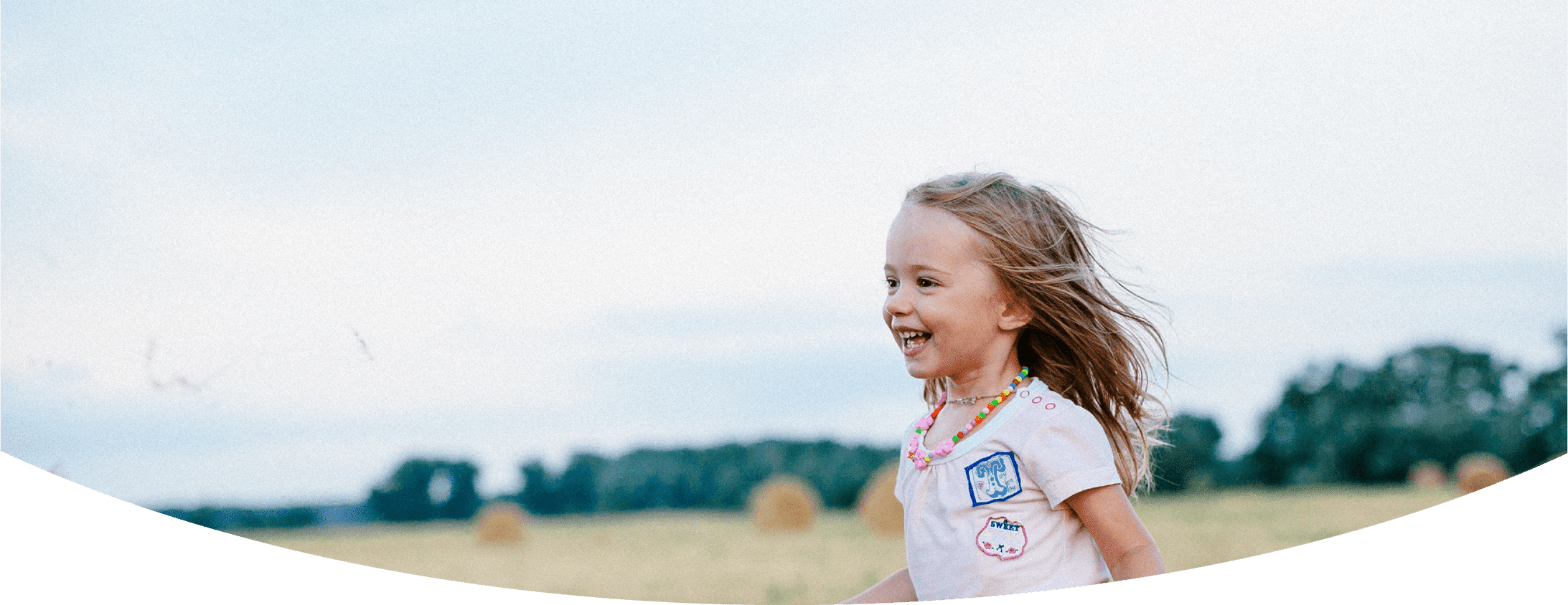 Happy girl running in a field